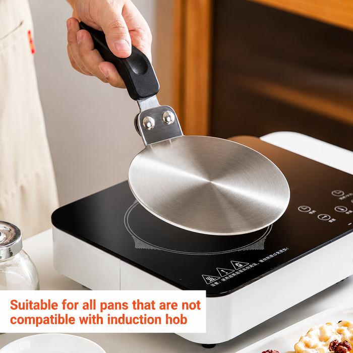 Hand placing By Kova induction adapter plate onto induction cooktop